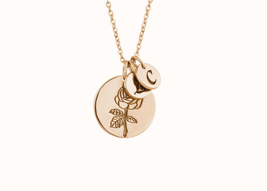 Engraved gold pendant necklace with initial charm.