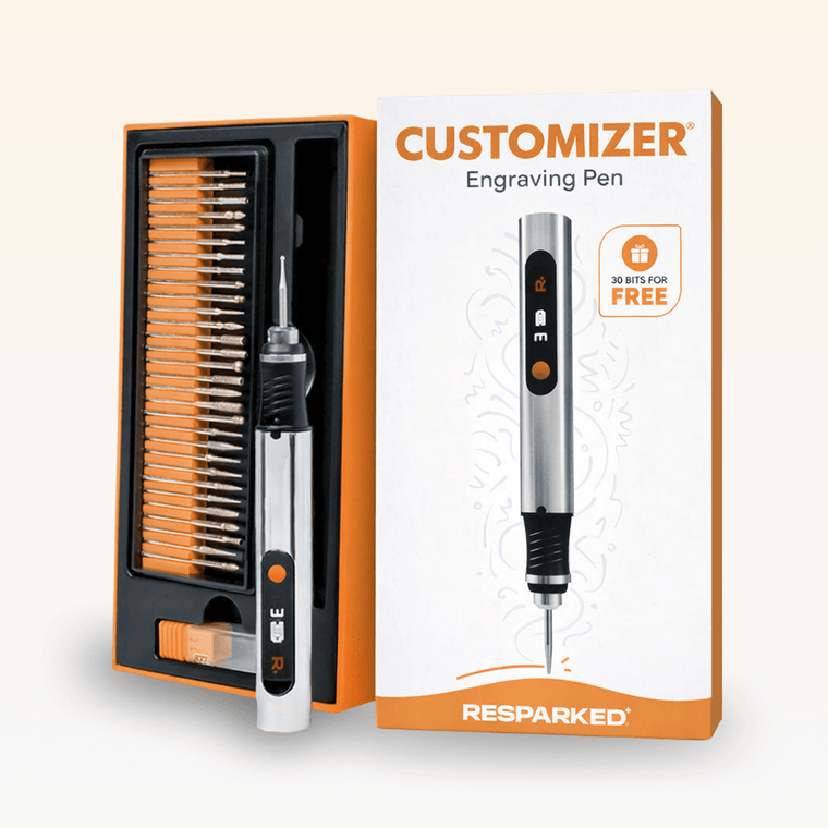 The Customizer engraving pen with its box and free gifts
