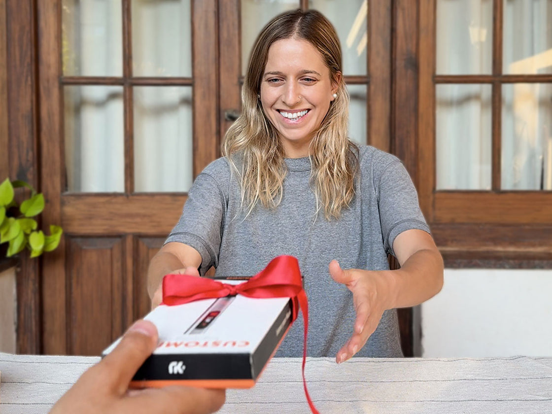Woman receiving the Customizer engraving pen as a gift