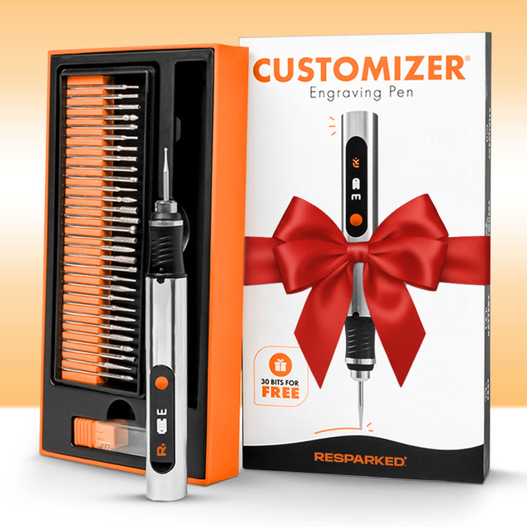 The Customizer engraving pen gift box with a red bow