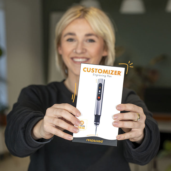 Holding the Customizer engraving pen with its packaging